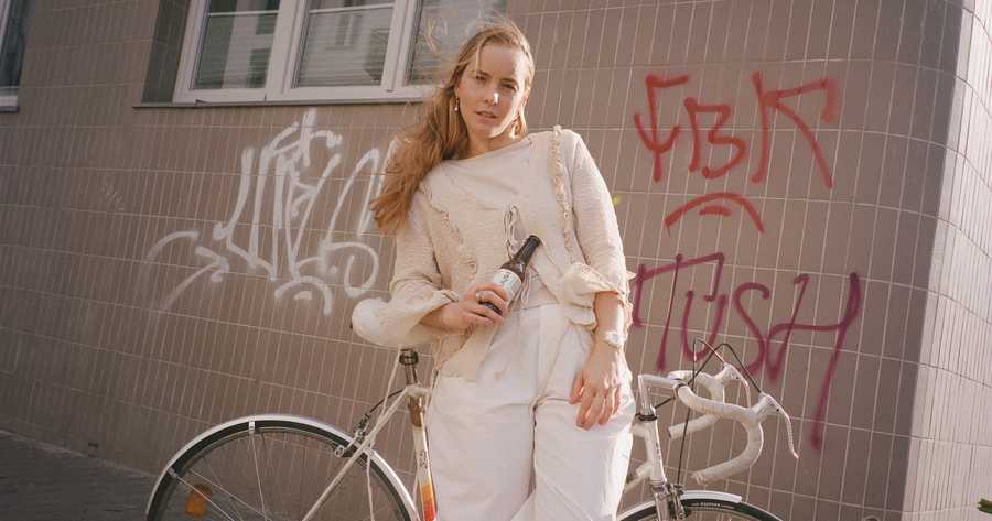 Estera Mrówka - blond girl, with a bike and bottle of shroom relax