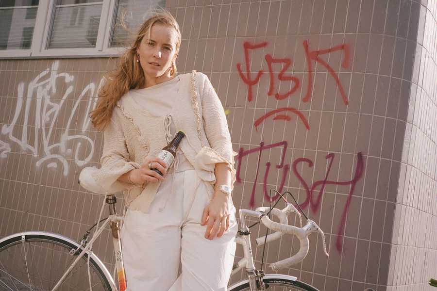 Estera MrĂłwka - blond girl, with a bike and bottle of shroom relax